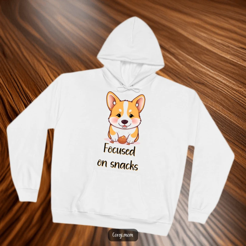 Funny Corgi hoodie, a Corgi intensely focused on a dropped treat, perfect for snack lovers.