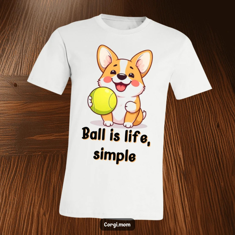 Funny Kawaii Corgi T-Shirt depicting a dog with a cheerful grin holding a tennis ball, perfect for lovers of cute and funny pet apparel.